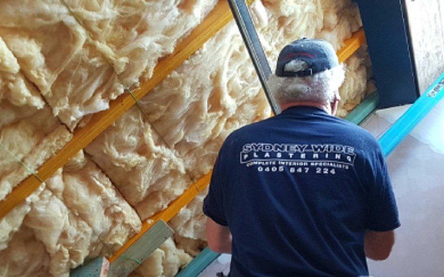 Sydney Wide Plastering plasterer at work next to ceiling insulation