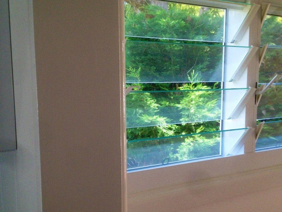 Freshly painted wall beside a louvre window