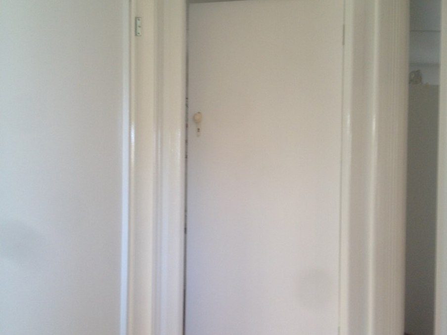 Newly lined gyprock wall and doorway, finished ready for paint